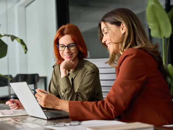 Okushon-become-agency-partner-two-office-woman-sitting-and-looking-at-laptop